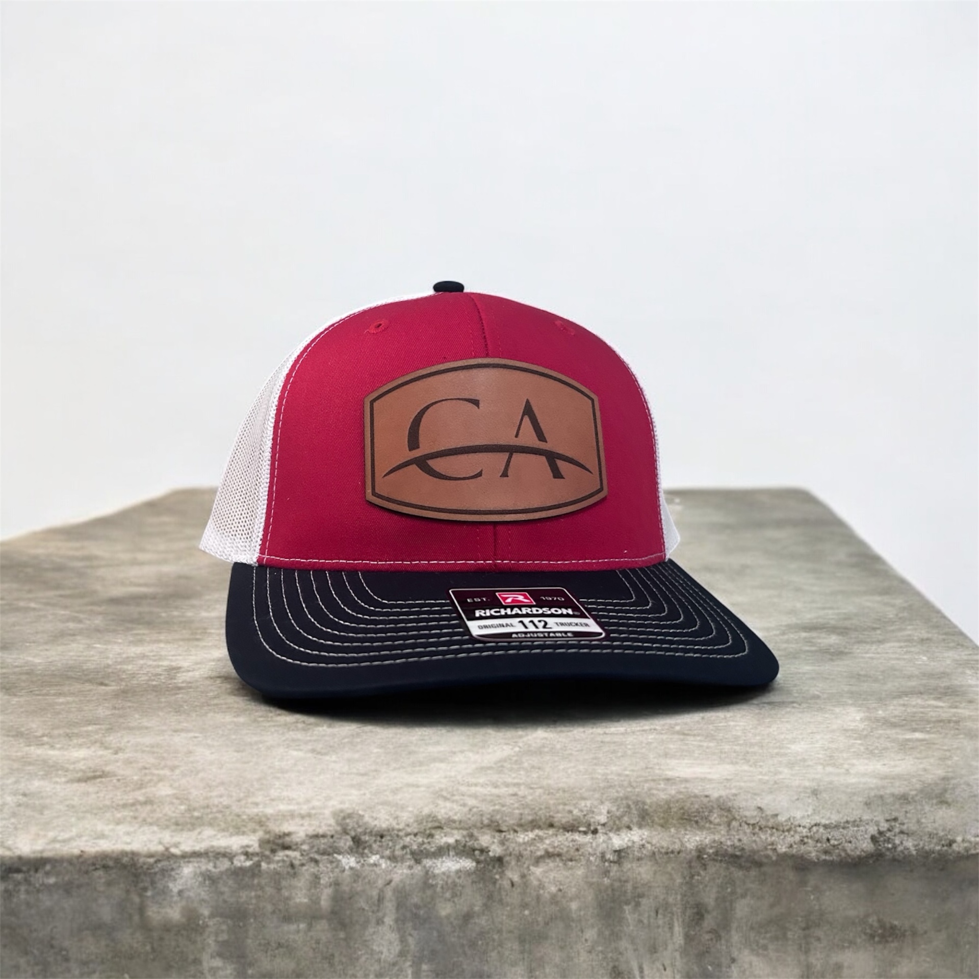 CA — Richardson 112 red/white/navy · leather patch logo