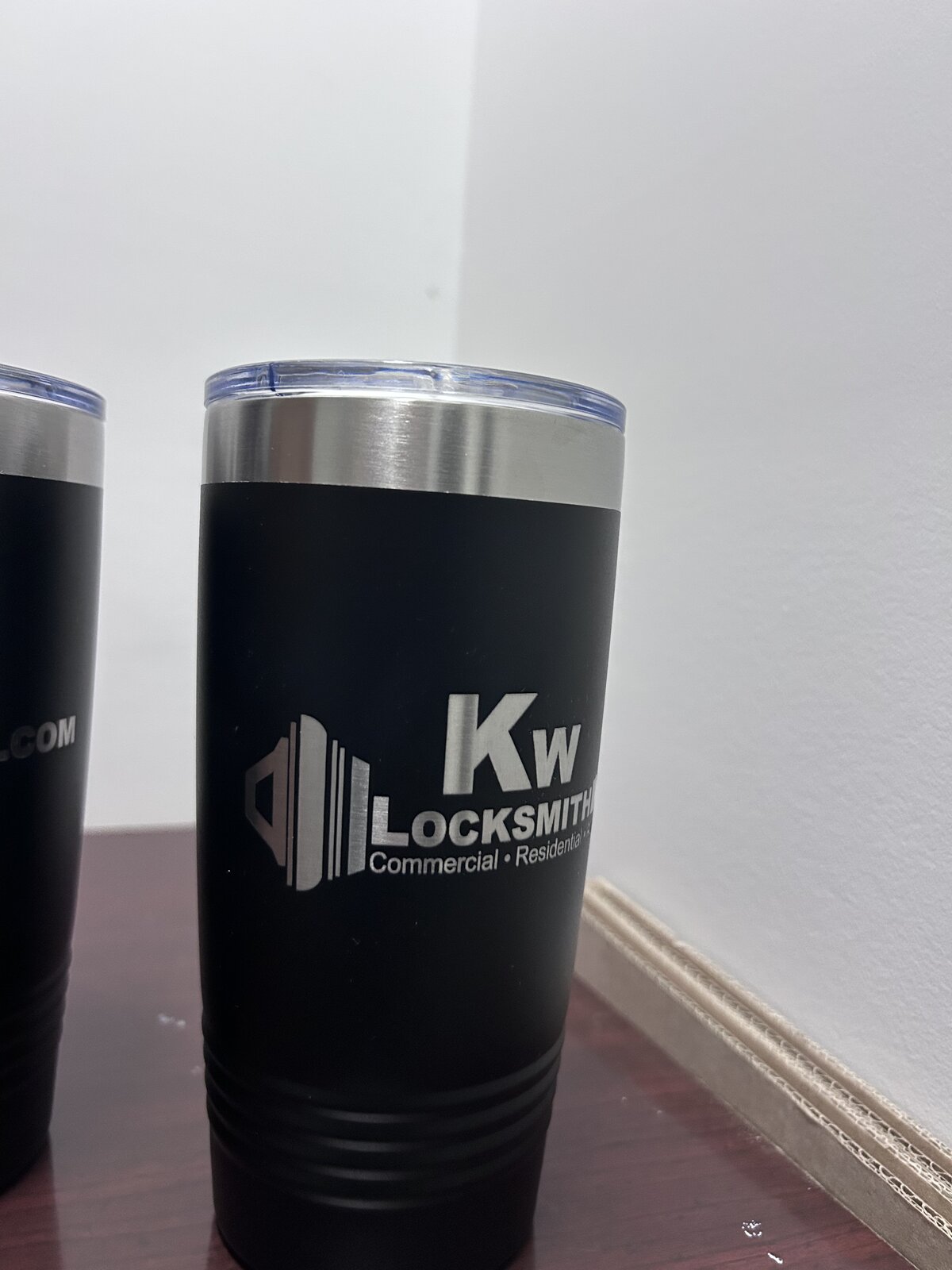KW Locksmith — Close up of engraved locksmith logo on matte black