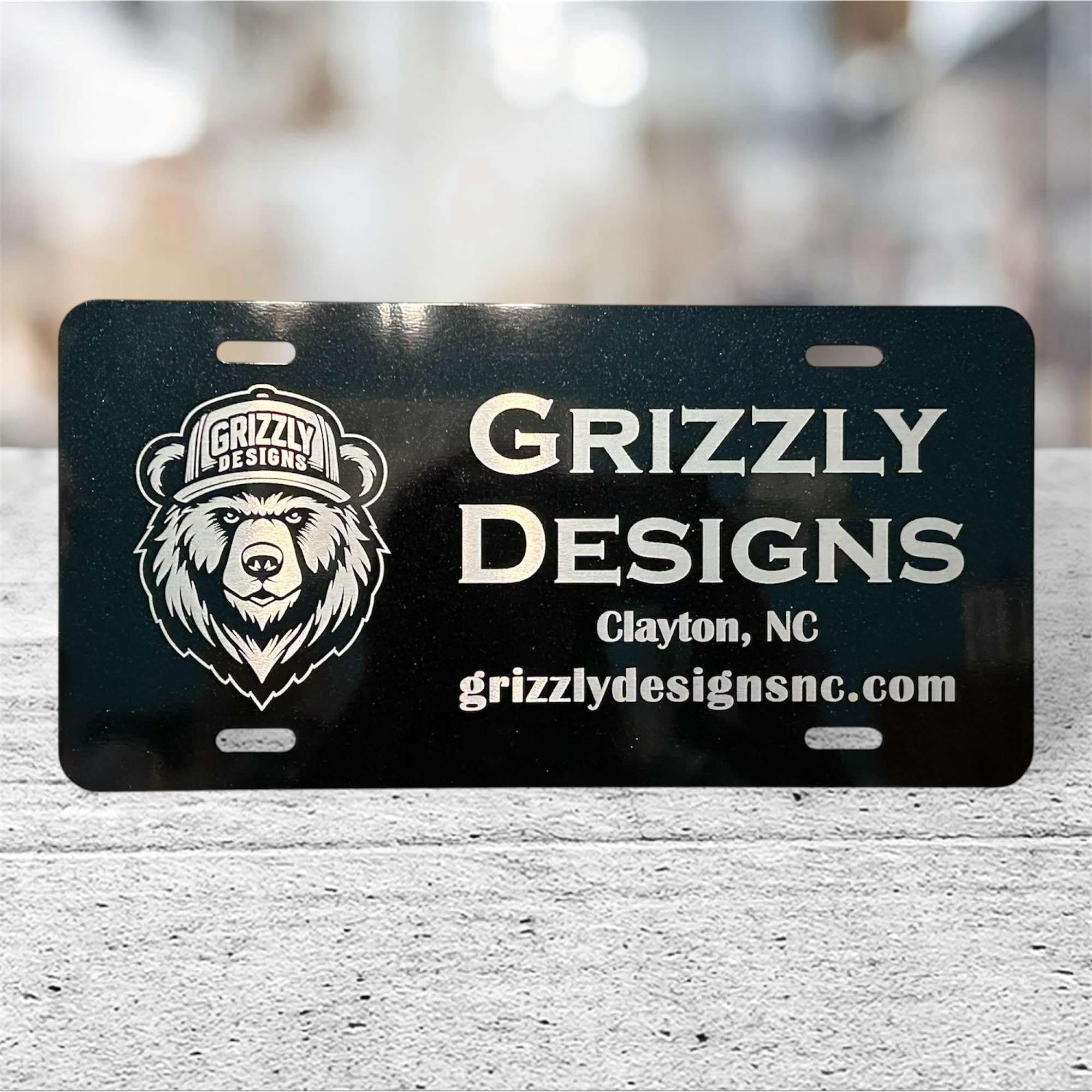 Grizzly Designs — Aluminum vanity plate · engraved logo and web address